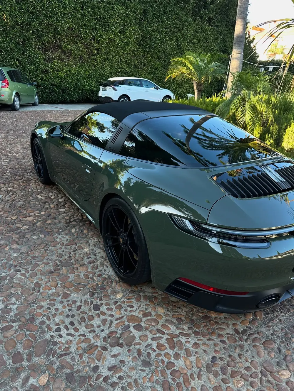 Green sports car with clean glossy paintwork after detailing