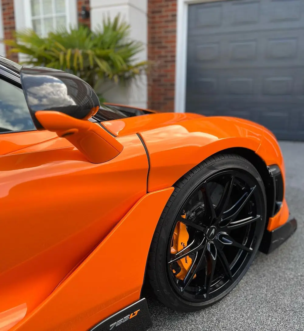 Detailed orange performance car with clean wheels and glossy paint